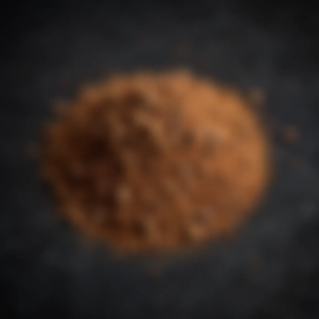 Allspice powder sprinkled on a dark background, highlighting texture