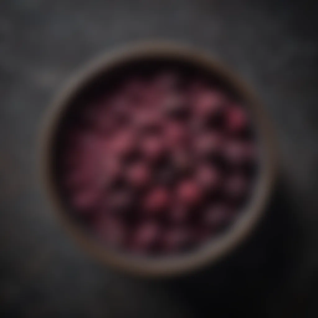 A close-up of vibrant black raspberry powder in a bowl, showcasing its rich color and texture.