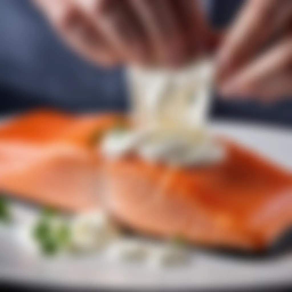 Cream cheese being gently spread over the salmon