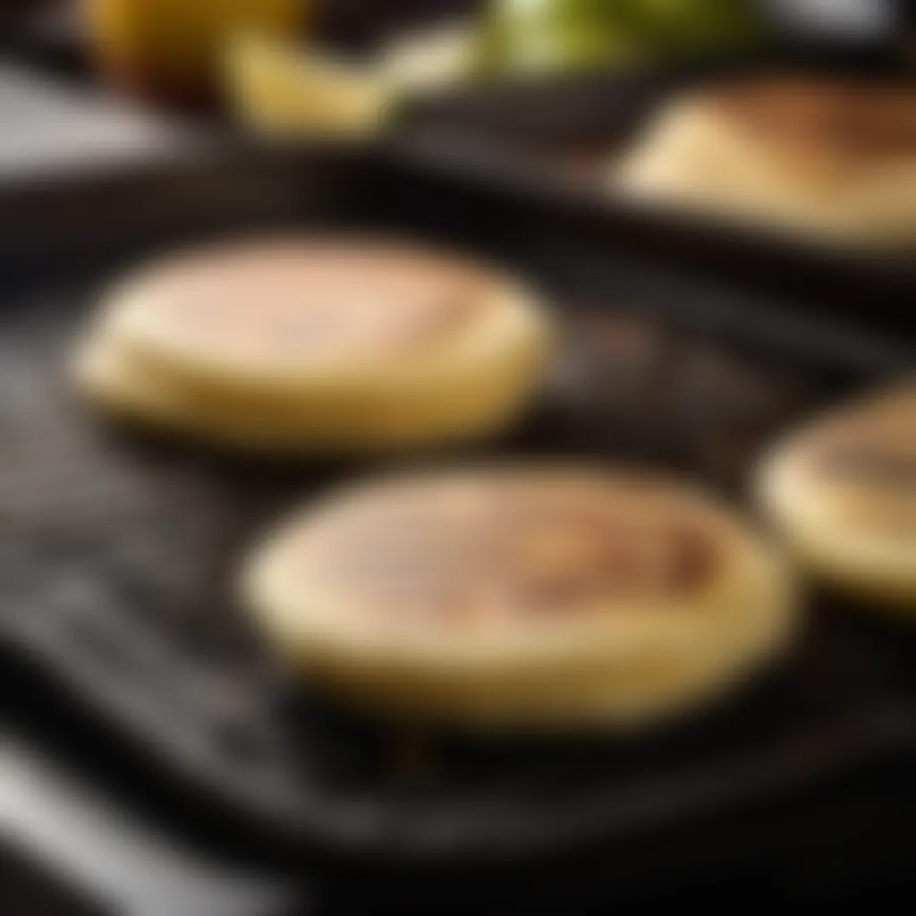 Golden arepas sizzling on a hot griddle