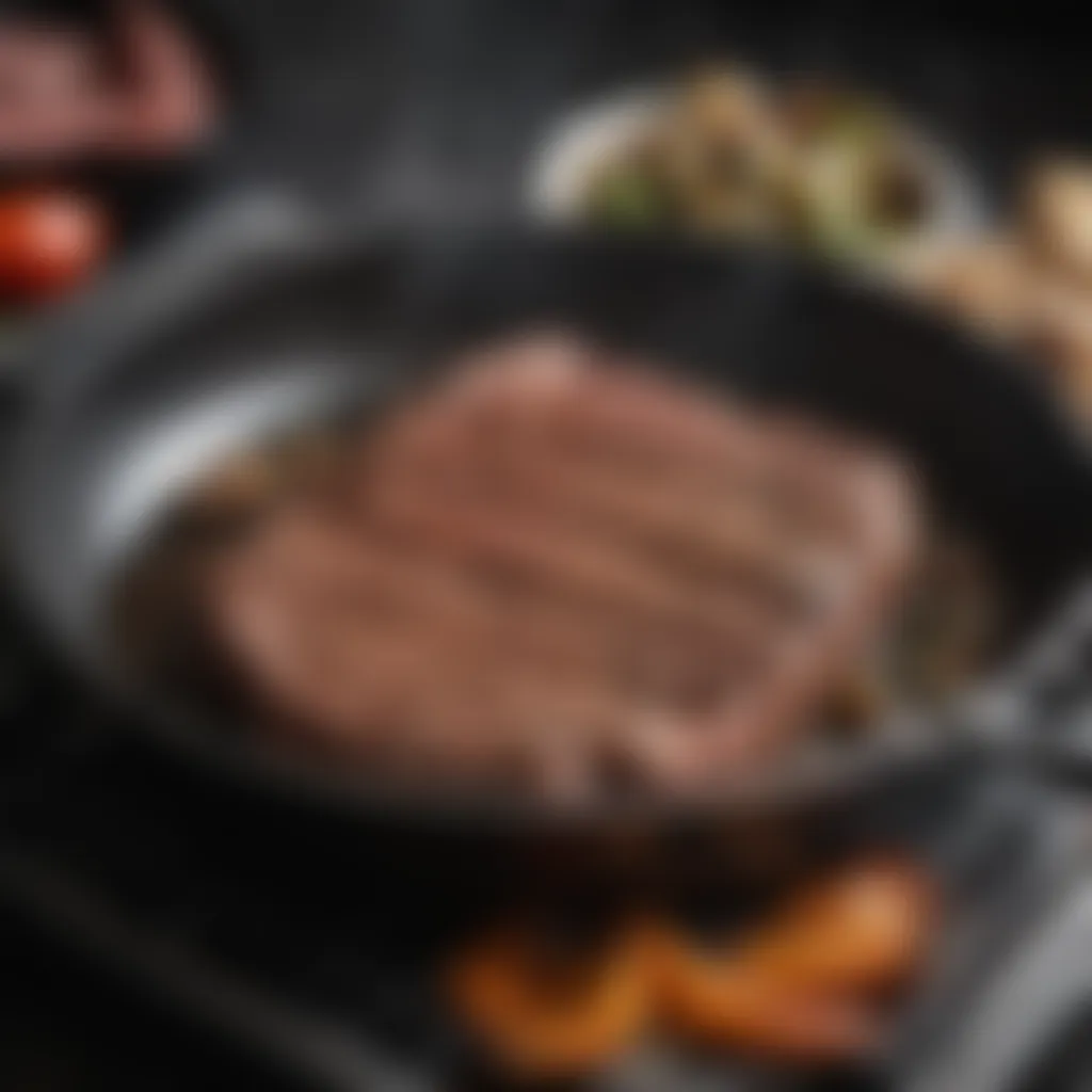 Seasoned steak being seared in a cast iron pan