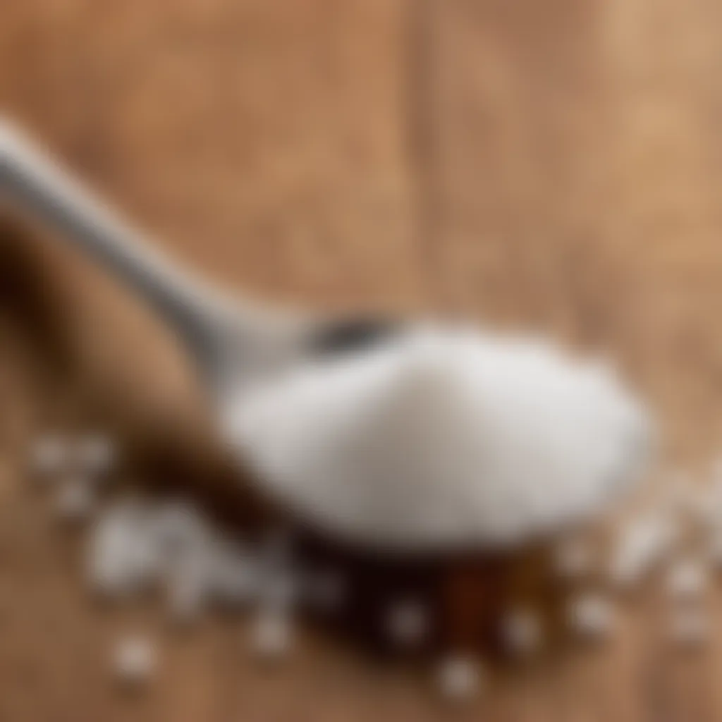 Teaspoon of granulated sugar on a wooden surface