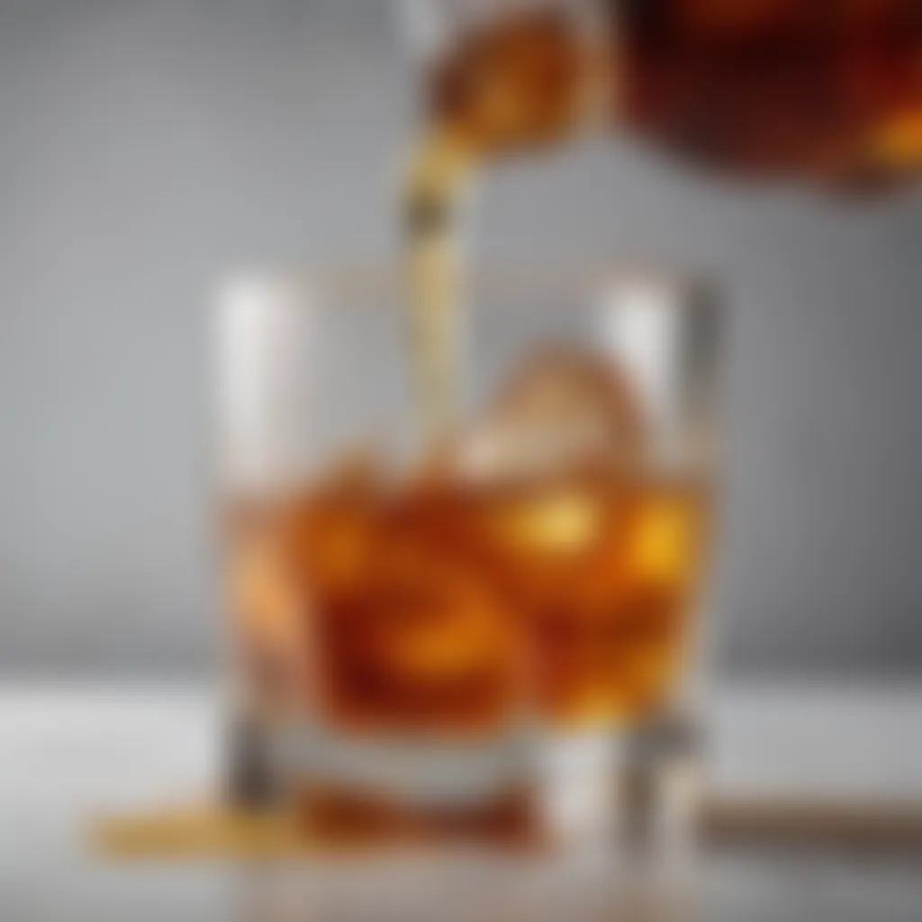 A close-up of a whiskey glass with honey drizzling elegantly beside it